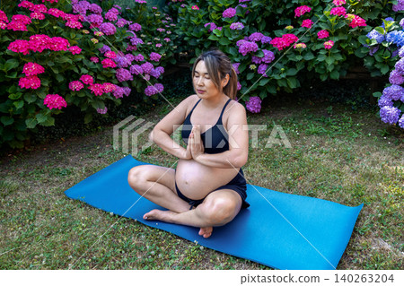 Pregnant woman practicing prenatal yoga in a lotus position, finding tranquility and balance amidst a vibrant garden, promoting health and wellness during pregnancy Pregnant woman practicing prenatal yoga in a lotus position, finding tranquility and balance amidst a vibrant garden, promoting health and wellness during pregnancy 140263204