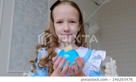 Girl Holding Blue Gift Box, Closeup Portrait With Gentle Smile, Headband And Curled Hair, Blurred Cake Tower Background, Pastel Tones, Intimate Celebratory Moment And Warm Emotion Girl Holding Blue Gift Box, Closeup Portrait With Gentle Smile, Headband And Curled Hair, Blurred Cake Tower Background, Pastel Tones, Intimate Celebratory Moment And Warm Emotion 140263476