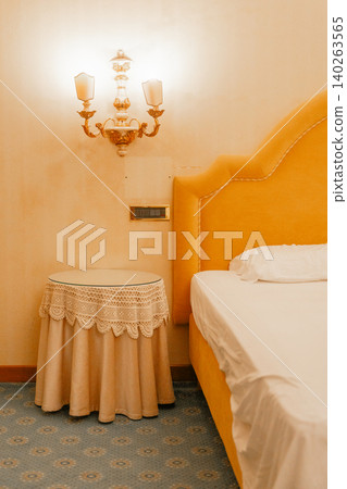 Classic style bedroom corner with decorative furniture and soft illumination. Concept of comfort and timeless interior aesthetics. 140263565