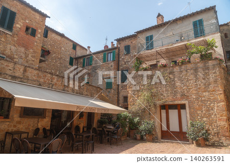 Cozy courtyard cafe in a historic Italian town with stone walls and outdoor seating. Warm Mediterranean atmosphere perfect for travel, leisure and European lifestyle themes. Cozy courtyard cafe in a historic Italian town with stone walls and outdoor seating. Warm Mediterranean atmosphere perfect for travel, leisure and European lifestyle themes. 140263591