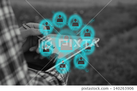 HR manager using digital tablet with holographic network interface for employee recruitment. Close-up of hands holding tablet pc with glowing blue human resource icons, leadership and team management HR manager using digital tablet with holographic network interface for employee recruitment. Close-up of hands holding tablet pc with glowing blue human resource icons, leadership and team management 140263906