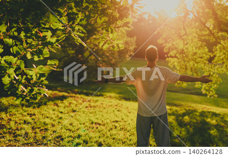 Man with Open Arms Embracing Sunlight Outdoors Man with Open Arms Embracing Sunlight Outdoors 140264128