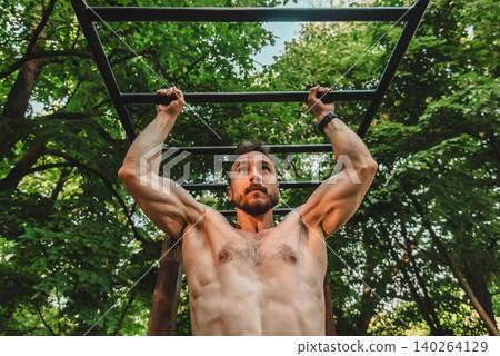 Man Doing Pull Up Training In Nature 140264129