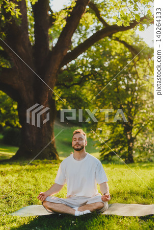 Man Meditating Under Large Tree Man Meditating Under Large Tree 140264133