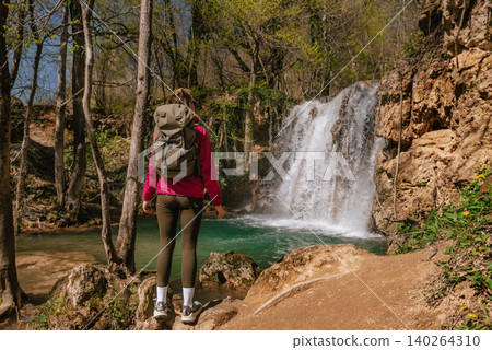 Female Traveler Standing near Forest Waterfall Female Traveler Standing near Forest Waterfall 140264310