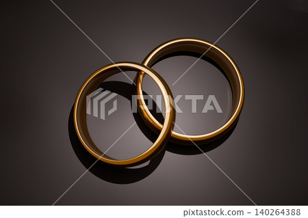 Two gold wedding rings on dark luxury background, elegant bridal jewelry concept Two gold wedding rings on dark luxury background, elegant bridal jewelry concept 140264388