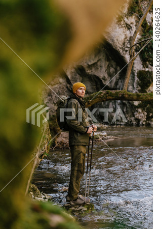 Hiker with Backpack Trekking in River Canyon in Nature Hiker with Backpack Trekking in River Canyon in Nature 140264625