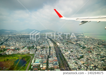 Plane takes off over city of Da Nang in Vietnam, aerial view from inside of cabin porthole at city 140264675