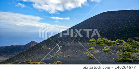 Scenic view of volcanic landscape with black soil, green vegetation, and blue ocean under a clear sky on the island of La Palma in the Canary Islands. High quality photo Scenic view of volcanic landscape with black soil, green vegetation, and blue ocean under a clear sky on the island of La Palma in the Canary Islands. High quality photo 140264677