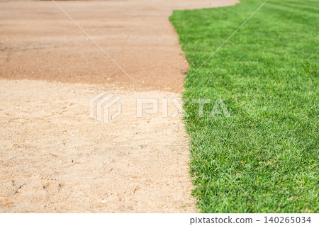 Rolled turf prepared for seasonal renewal and installation, laid on wet soil in city park Rolled turf prepared for seasonal renewal and installation, laid on wet soil in city park 140265034