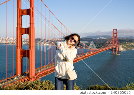 Woman smiling at Golden Gate Bridge overlook in San Francisco Woman smiling at Golden Gate Bridge overlook in San Francisco 140265035