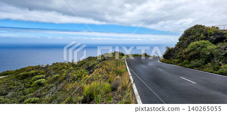 Scenic coastal road winding along cliffside with lush greenery and ocean view in a tropical landscape. High quality photo Scenic coastal road winding along cliffside with lush greenery and ocean view in a tropical landscape. High quality photo 140265055