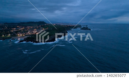 Aerial view of rocky Atlantic coast and seaside town at dusk Aerial view of rocky Atlantic coast and seaside town at dusk 140265077