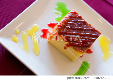 Tasty dessert cheese cake served at plate with different cream 140265200