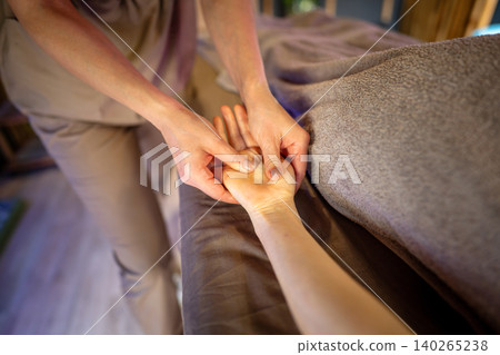 Healing massage treatment, professional female specialist masseuse massaging woman patient arm. Healing massage treatment, professional female specialist masseuse massaging woman patient arm. 140265238