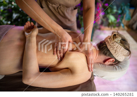 Professional lady masseuse in spa salon making manual physiotherapy treatment massage for woman. Professional lady masseuse in spa salon making manual physiotherapy treatment massage for woman. 140265281