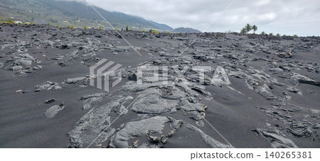 Black volcanic landscape with hardened lava formations and sparse vegetation on Island La Palma after the eruption of the Tajogaite volcano. High quality photo Black volcanic landscape with hardened lava formations and sparse vegetation on Island La Palma after the eruption of the Tajogaite volcano. High quality photo 140265381