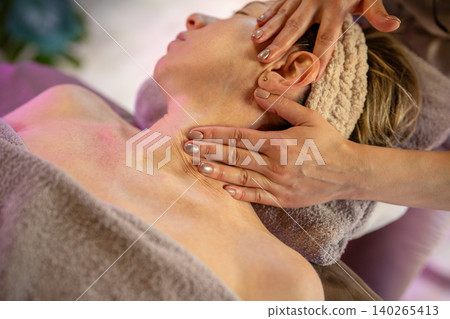 Woman getting relaxing body massage in medical clinic under care of professional masseuse therapist. Woman getting relaxing body massage in medical clinic under care of professional masseuse therapist. 140265413