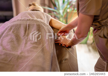 Professional therapy session in beauty clinic, female masseuse specialist massaging relaxed woman. Professional therapy session in beauty clinic, female masseuse specialist massaging relaxed woman. 140265443