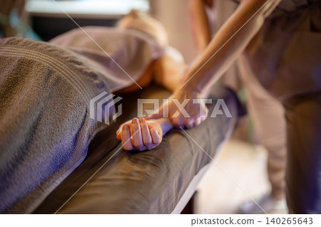 Woman relaxing in spa salon and getting arms massage, professional beauty treatment for body health. Woman relaxing in spa salon and getting arms massage, professional beauty treatment for body health. 140265643
