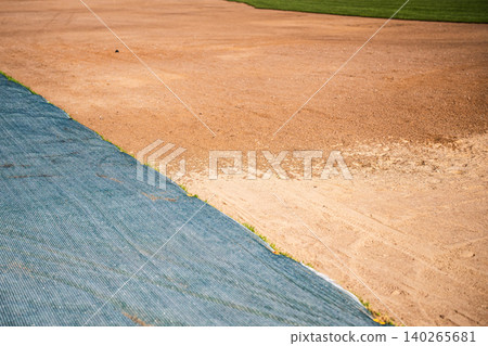 Part of ground covered with special protective net to prevent seeds damage, grass lawn preparations. Part of ground covered with special protective net to prevent seeds damage, grass lawn preparations. 140265681