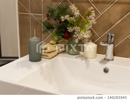 Modern Bathroom Basin Detail with Rolled Towel and Potted Lavender Plant 140265945