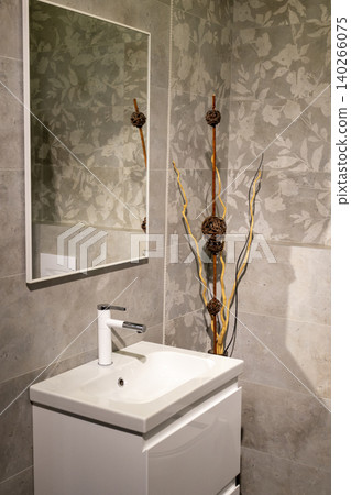 Contemporary Restroom Decor Featuring Ceramic Sink and Textured Geometric Wall 140266075