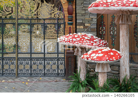 Mushrooms near a decorative gate in a garden Mushrooms near a decorative gate in a garden 140266105