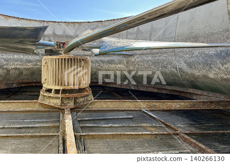 Looking up at a large industrial fan in a factory Looking up at a large industrial fan in a factory 140266130