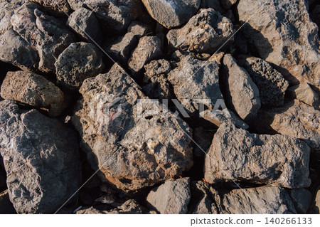 Pile of sharp broken stones and rubble close-up forming an uneven construction industry background 140266133