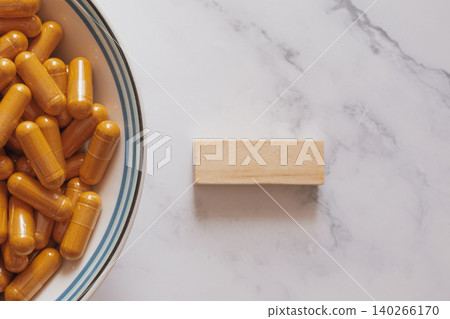 Natural curcumin capsules on marble and wood, showcasing clean eco-friendly wellness aesthetics with bright botanical supplements for modern biohacking and minimalist health visuals Natural curcumin capsules on marble and wood, showcasing clean eco-friendly wellness aesthetics with bright botanical supplements for modern biohacking and minimalist health visuals 140266170