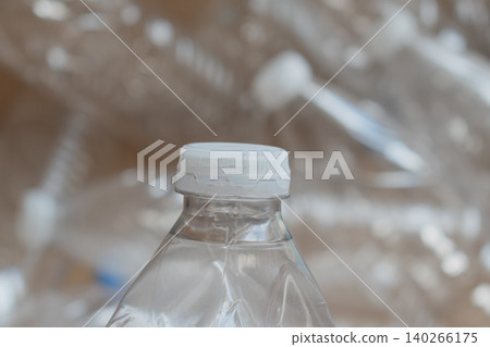 Clear plastic water bottles are packed in a cardboard box ready for recycling at a local facility Clear plastic water bottles are packed in a cardboard box ready for recycling at a local facility 140266175