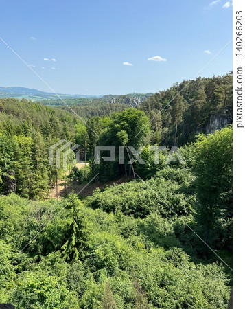 Scenic view of lush green forest landscape with distant hills and blue Scenic view of lush green forest landscape with distant hills and blue 140266203
