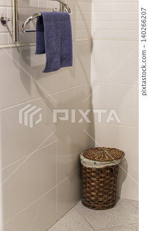 White Acrylic Bath Corner with Rolled Towel and Woven Hamper on Floor White Acrylic Bath Corner with Rolled Towel and Woven Hamper on Floor 140266207