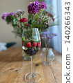 Glass of infused water with berries and mint on wooden table 140266343