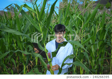 Agricultural researcher recording crop results on clipboard Agricultural researcher recording crop results on clipboard 140266395