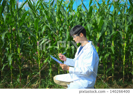 Agricultural researcher recording crop results on clipboard Agricultural researcher recording crop results on clipboard 140266400