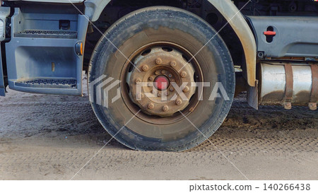 A truck wheel in a parking lot during operation 140266438