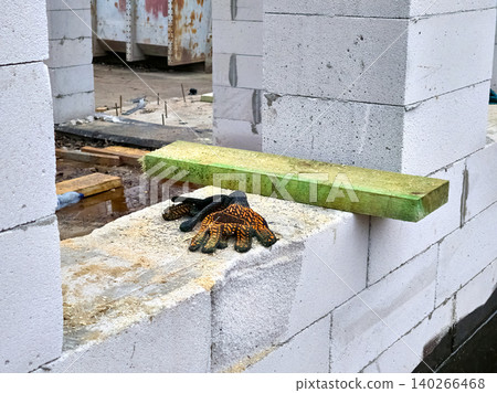 Protective gloves for workers hands on construction site 140266468