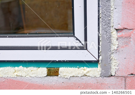 Construction installing.Metal plastic window on pink brick wall Construction installing.Metal plastic window on pink brick wall 140266501