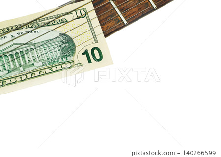 Money fee.Ten dollars bill banknote on a rock electric guitar Money fee.Ten dollars bill banknote on a rock electric guitar 140266599