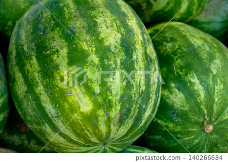 Summer joy. Pile of ripe watermelons at the market Summer joy. Pile of ripe watermelons at the market 140266684