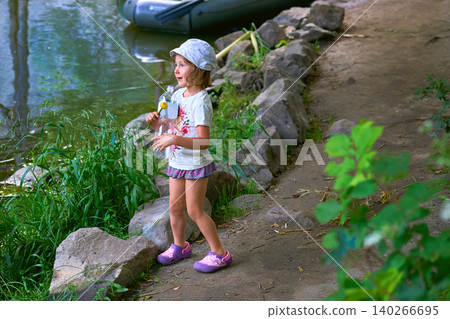 Cheerful young girl baby tourist traveler admires the views Cheerful young girl baby tourist traveler admires the views 140266695