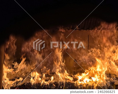 Fire Burning Brightly in the Oven at a Late Night Gathering in the Kitchen Fire Burning Brightly in the Oven at a Late Night Gathering in the Kitchen 140266825