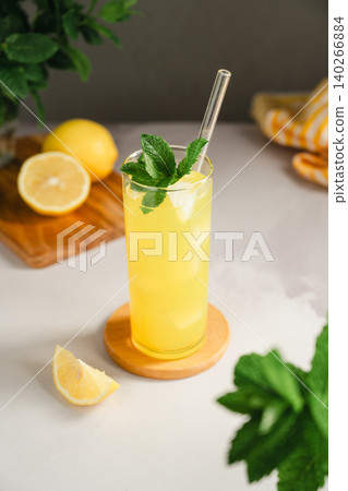 Fresh lemonade with mint and ice in tall glass, summer refreshment drink concept Fresh lemonade with mint and ice in tall glass, summer refreshment drink concept 140266884