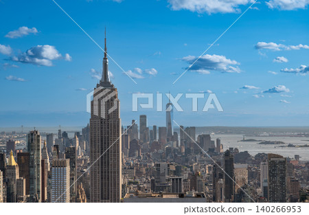 New york, usa august 21,2024. New york city skyline featuring empire state building and one world trade center against a bright blue sky with clouds New york, usa august 21,2024. New york city skyline featuring empire state building and one world trade center against a bright blue sky with clouds 140266953