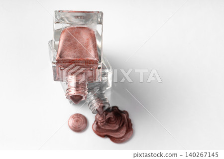 Close up of a nail polish puddle over white background Close up of a nail polish puddle over white background 140267145