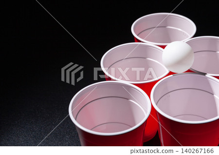 Beer pong college game on black background 140267166