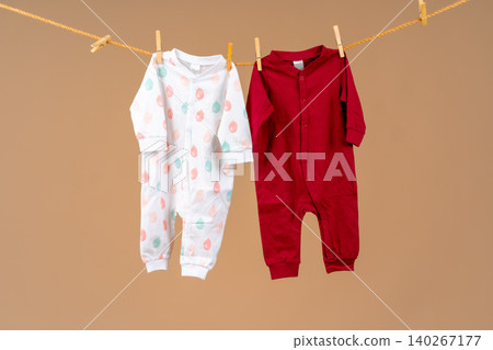 Kid's apparel pinned to a clothesline to dry Kid's apparel pinned to a clothesline to dry 140267177