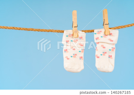 Baby socks on a clothesline. Baby clothes washing Baby socks on a clothesline. Baby clothes washing 140267185